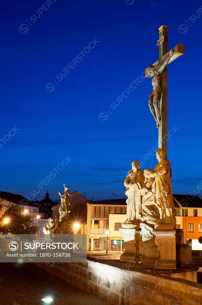 Statue of Crucified Jesus Christ on Kamenny Most, the oldest Gothic stone bridge in Czech Republic, at dusk, Pisek, Budejovicko, Czech Republic, Europ...