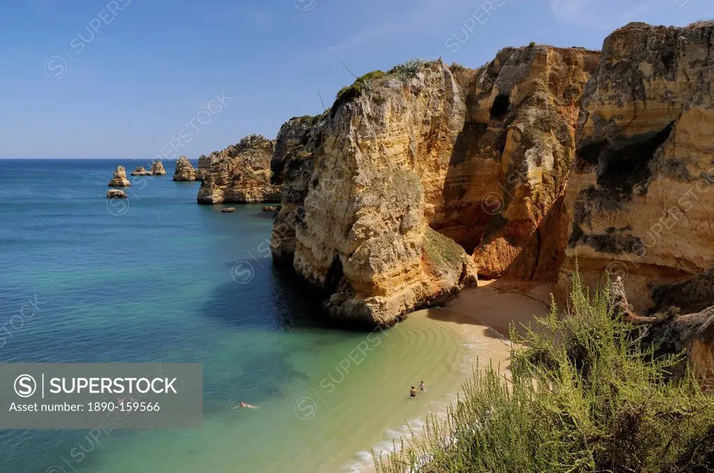 Weathered sandstone cliffs and sea stacks at Praia Dona Ana, Lagos, Algarve, Portugal, Europe