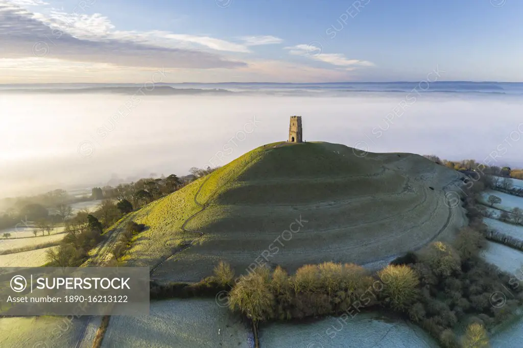 View by drone of St. Michael's Tower on Glastonbury Tor at dawn in winter, Somerset, England, United Kingdom, Europe