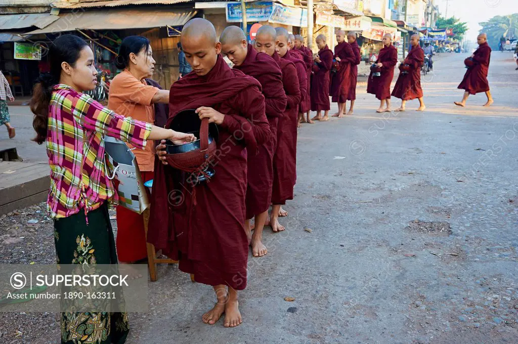 Buddhist monks procession receive offerings, Mawlamyine (Moulmein), Mon State, Myanmar (Burma), Asia