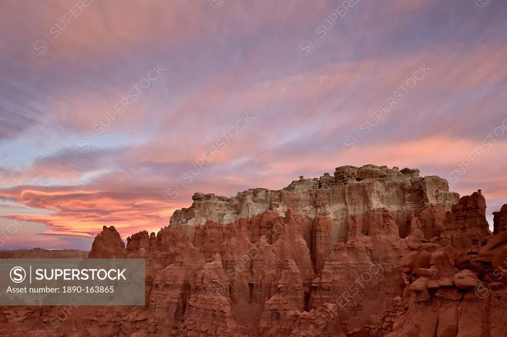 Orange clouds at dawn over the badlands, Goblin Valley State Park, Utah, United States of America, North America