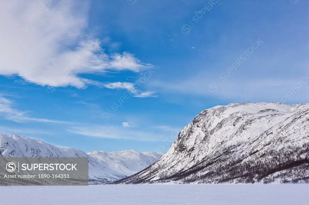 Mountains flank a frozen lake in Mosstrond, near the Hardanger Plateau, Norway, Scandinavia, Europe