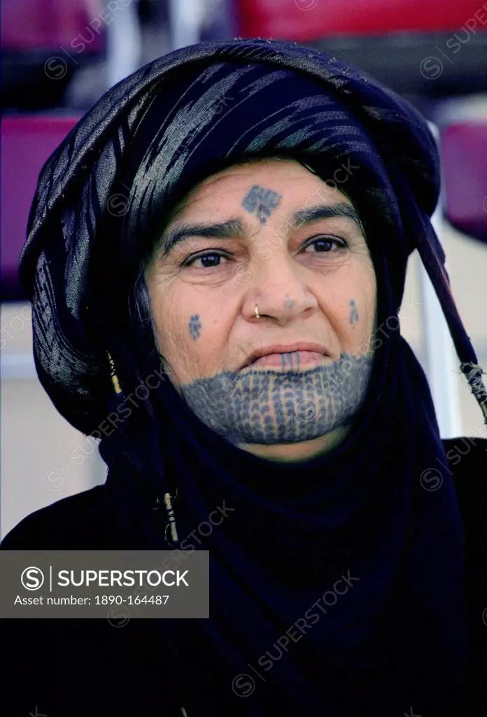 Woman with traditional tatooed markings on her face, Qatar
