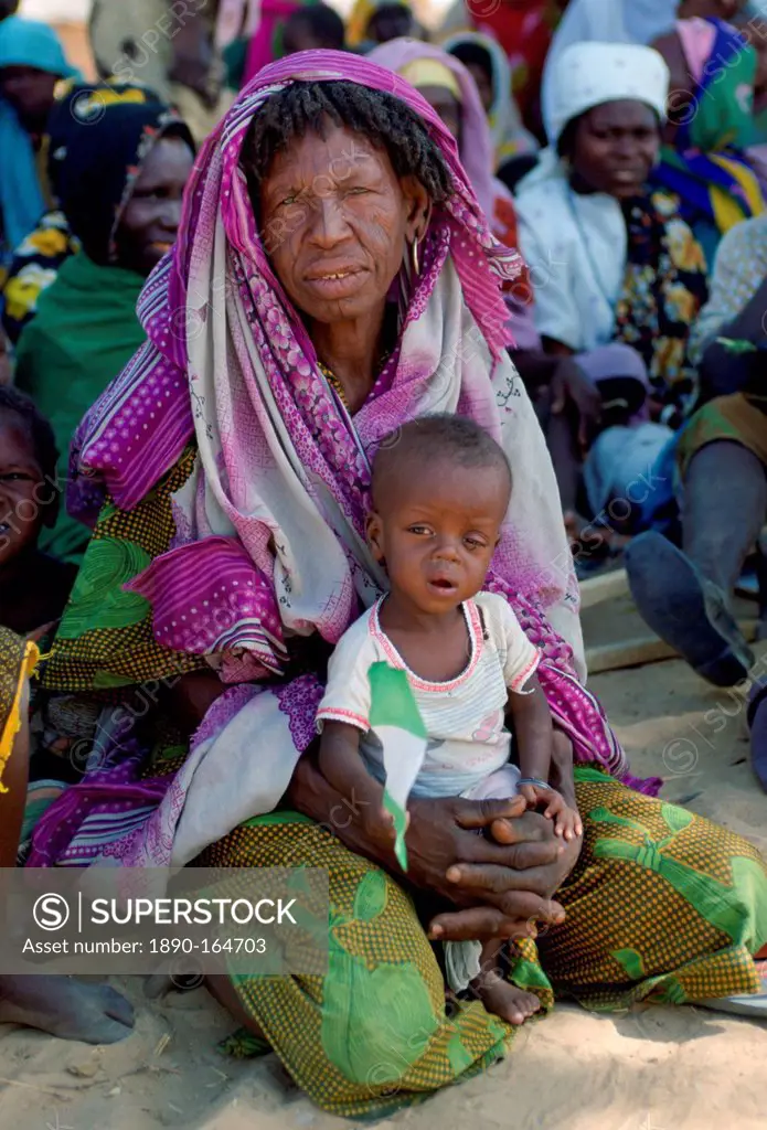 Woman sitting holding a child in Northern Nigeria