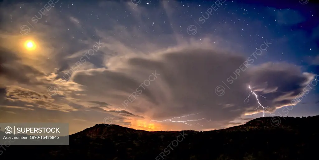 An isolated storm cell near Chino Valley being lit by the Moonlight during the summer monsoon season, Arizona, United States of America, North America
