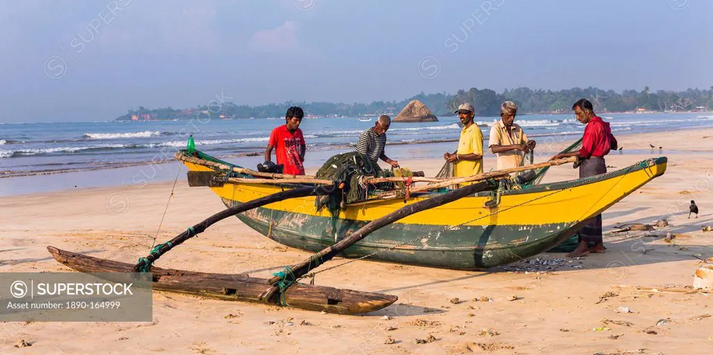 Fishermen sorting their catch on Weligama Beach, South Coast of Sri Lanka, Asia