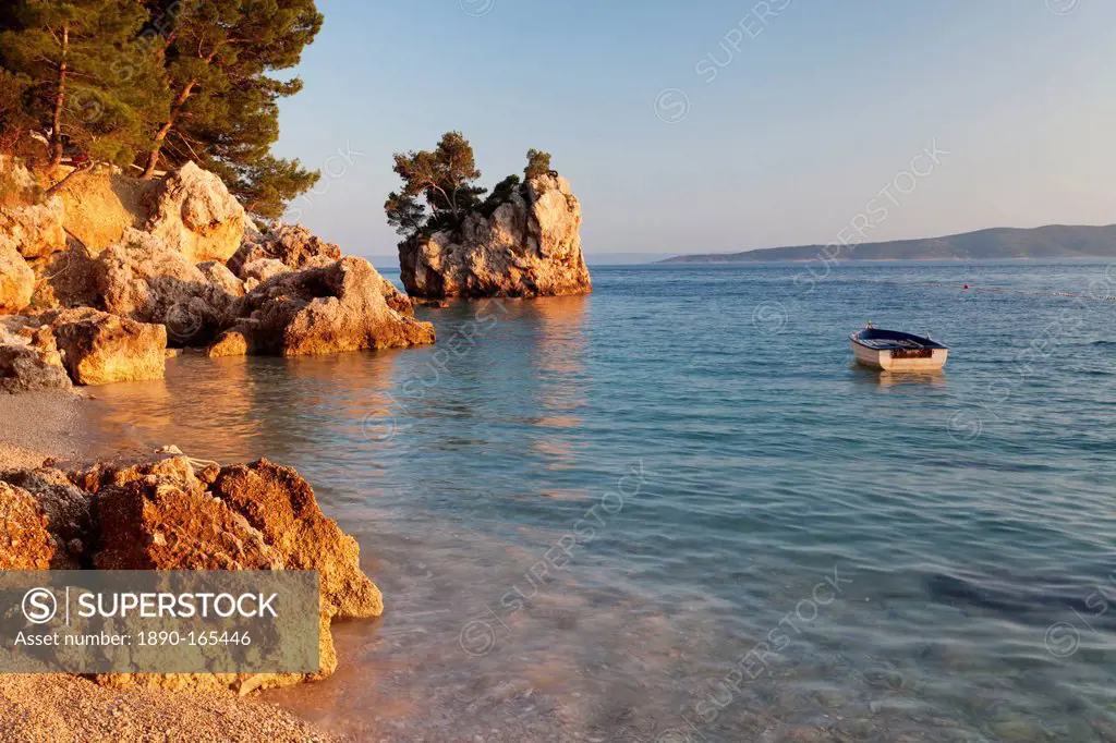 Coastal landscape with a rock and a rowing boat, Brela, Makarska Riviera, Dalmatia, Croatia, Europe