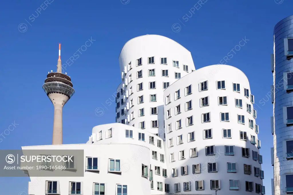 Neuer Zollhof, designed by Frank Gehry, and Rheinturm tower, Media Harbour (Medienhafen), Dusseldorf, North Rhine Westphalia, Germany, Europe