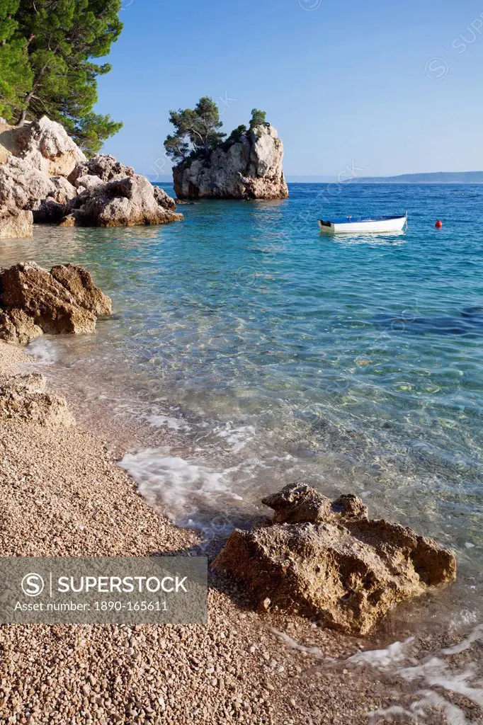 Rock and rowing boat, near Brela, Makarska Riviera, Dalmata, Croatia, Europe