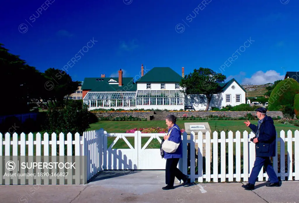 People walking past Government House in Port Stanley, Falkland Islands