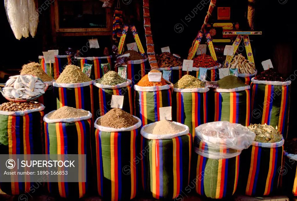 Brightly coloured sacks of spices and nuts on sale in the Souk in Cairo, Egypt