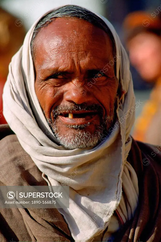 A grey haired bearded old man with his head covered, Agra, India