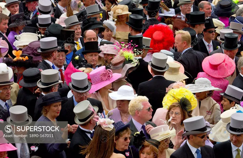 Crowd of racegoers in traditional top hats, tails and dramatic fashions at Royal Ascot Races