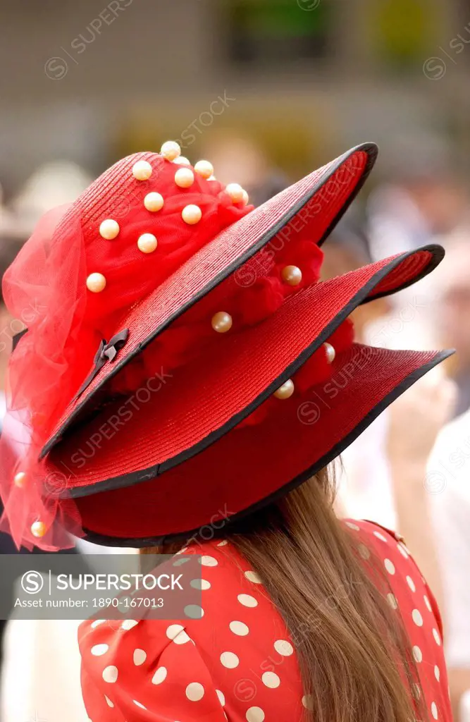 Race-goer in true Ascot fashion wearing a matching spotted dress and three tiered hat at Royal Ascot Races