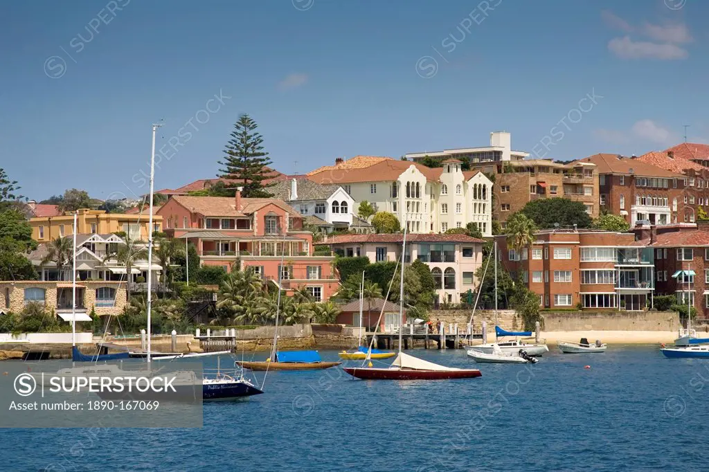 Yachts moored, Sydney Harbour waterfront residences near Point Piper, Double Bay, Australia