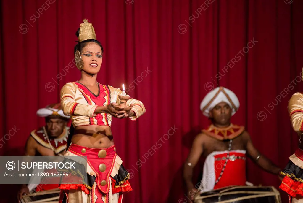 Woman dancing traditional Kandyan dance at a tourist show in Kandy, Sri Lanka, Asia