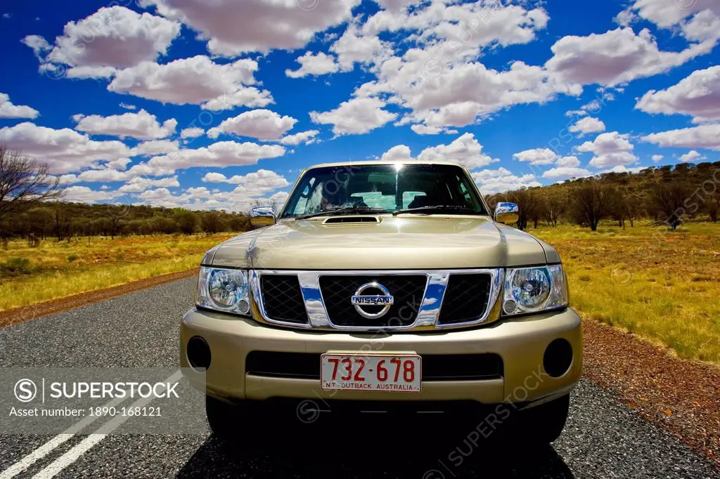 Four-wheel-drive Nissan Patrol vehicle on road in the Red Centre, Australia