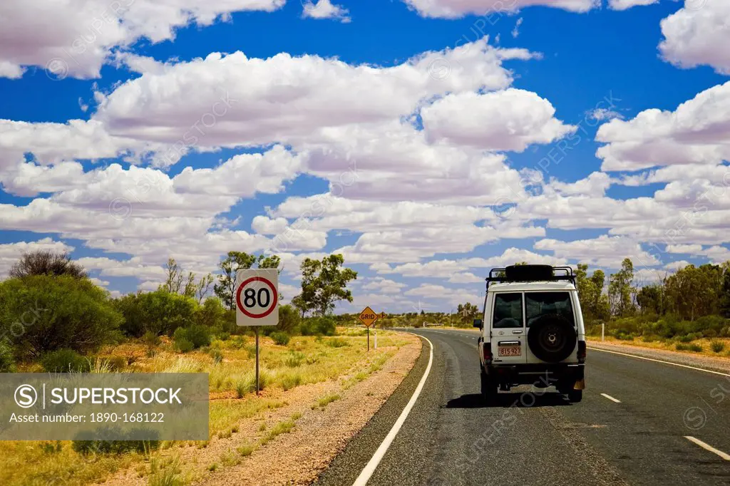 Four-wheel-drive vehicle on road in the Red Centre, Northern Territory, Australia