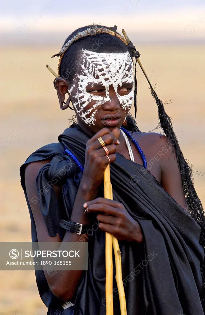 Young recently circumcised Masai Warrior (moran) with traditional face paint after 'coming of age' in the Serengei Plains, Tanzania