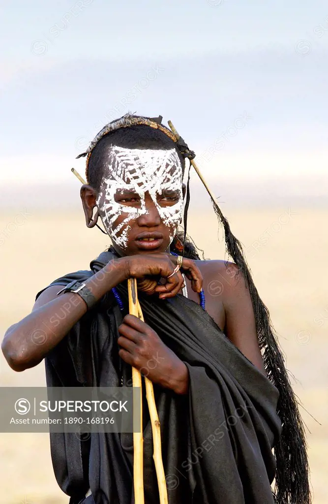 Young recently circumcised Masai Warrior (moran) with traditional face paint after 'coming of age' in the Serengei Plains, Tanzania