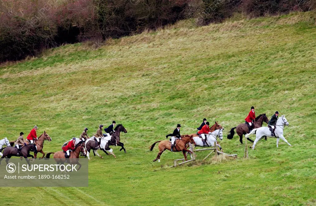 Huntsmen riding across fields during the Heythrop New Year's Day Hunt, Oxfordshire