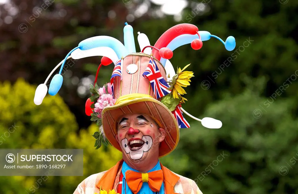 A clown laughing during a community picnic where local groups are providing musical and dance entertainment to celebrate the ethnic diversity of West ...