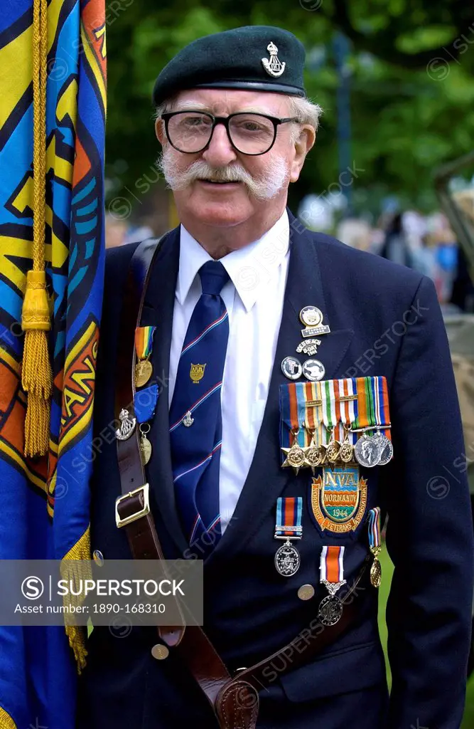 Veteran with handlebar moustache, beret, medals and flag in a parade of Veterans of the D-Day Landings at the start of the 60th Anniversary Commemorat...