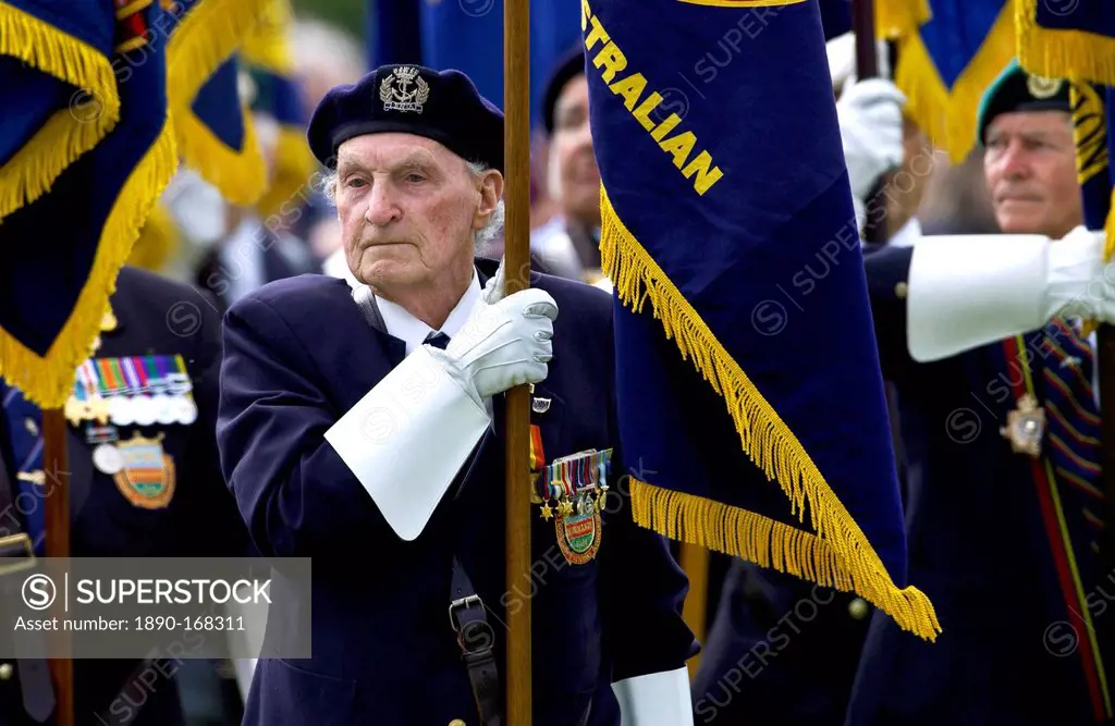 Veterans of the D-Day Landings with their flags in a parade at the start of the 60th Anniversary Commemorations.