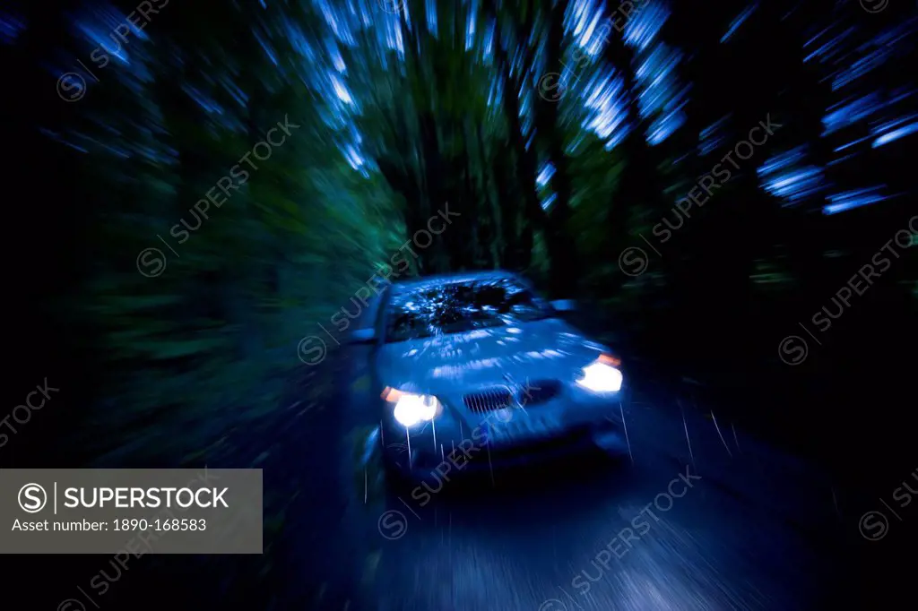 BMW car on country road at night, Gloucestershire, United Kingdom