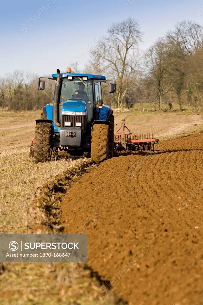 Tractor ploughing field in Oxfordshire, The Cotswolds, United Kingdom