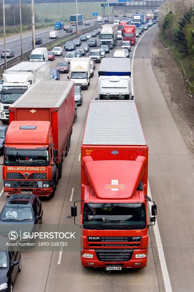 Royal Mail lorry travelling slowly among heavily congested traffic on M1 motorway in Hertfordshire, United Kingdom