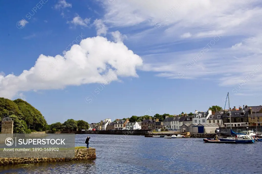 Man looks over at Stornoway harbour, Outer Hebrides, United Kingdom