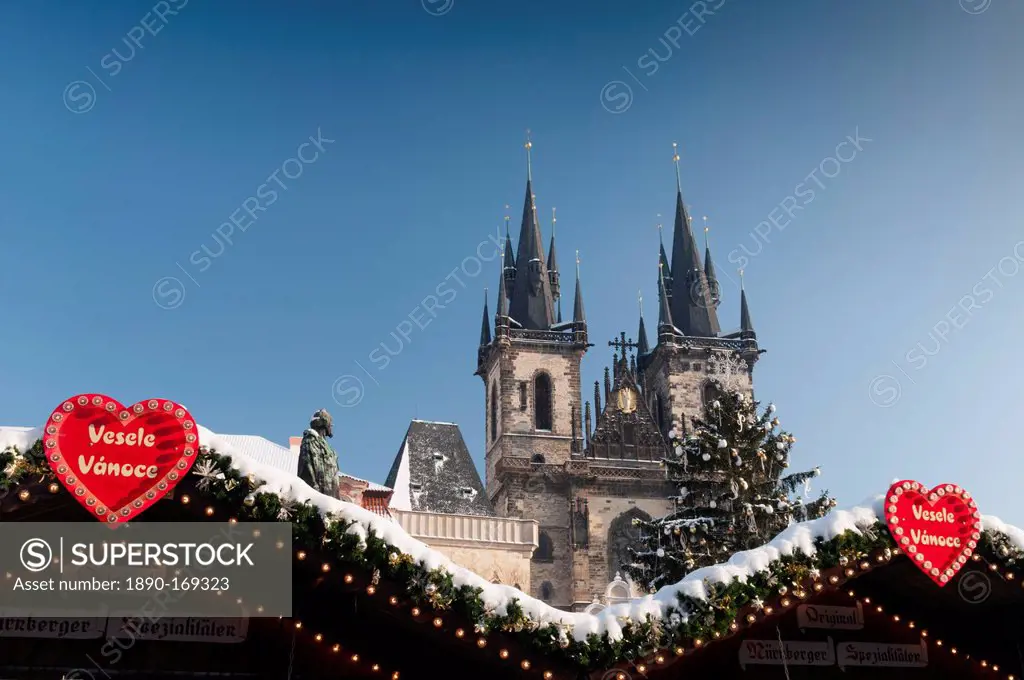 Merry Christmas sign at snow-covered Christmas Market and Tyn Church, Old Town Square, Prague, Czech Republic, Europe