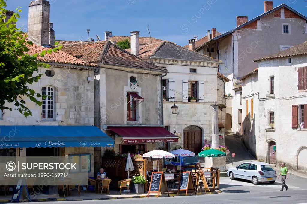 Tourists in quaint town of Bourdeilles popular tourist destination near Brantome in Northern Dordogne, France