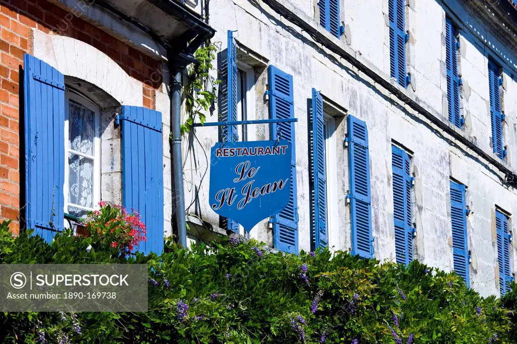Restaurant Le St Jean, typical French restaurant with blue window shutters and sign in St Jean de Cole, The Dordogne, France