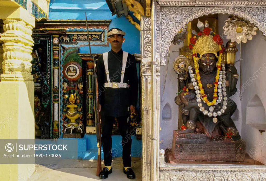 Ceremonial guard and garlanded religious statue, Kathmandu, Nepal