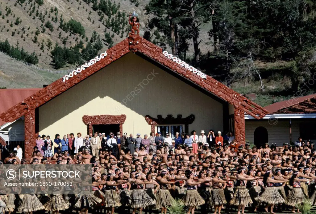 Maori women dancing at tribal gathering in front of the Wharenui meeting house at the Marae in New Zealand