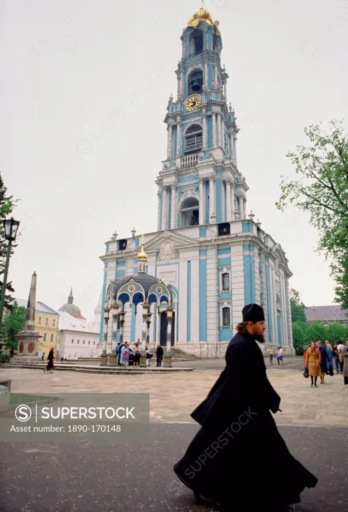Monk and bell tower of Trinity Lavra of St Sergius, Russian Orthodox monastery at Sergiyev Posad, Zagorsk, near Moscow, Russia