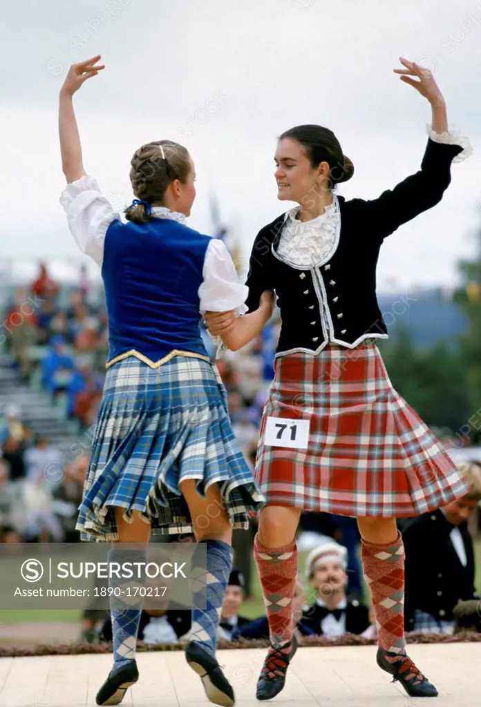 Scottish girls in tartan kilts dancing traditional dance at the Braemar Royal Highland Gathering, the Braemar Games in Scotland