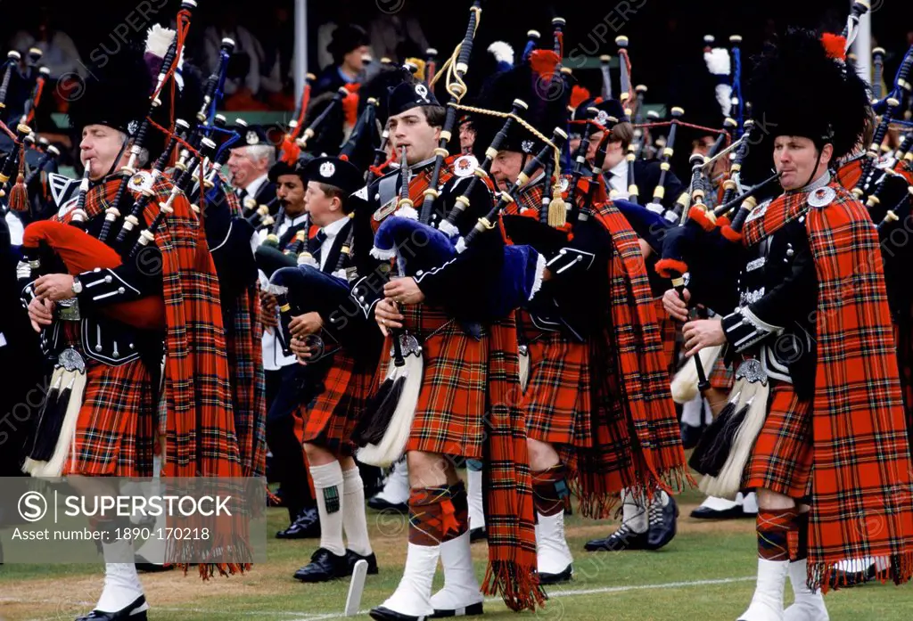 Traditional Scottish band in tartan kilts marching at the Braemar Royal Highland Gathering, the Braemar Games in Scotland
