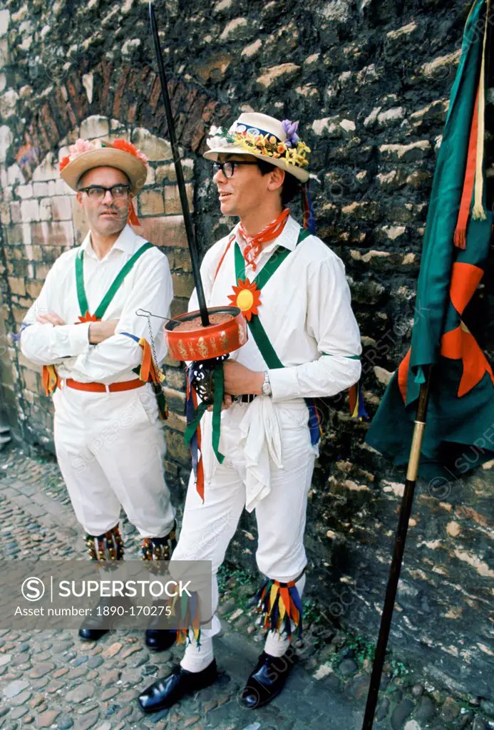Traditional English Morris Men in costume with bells and floral hats at a Morris dancing festival in Cambridge, UK