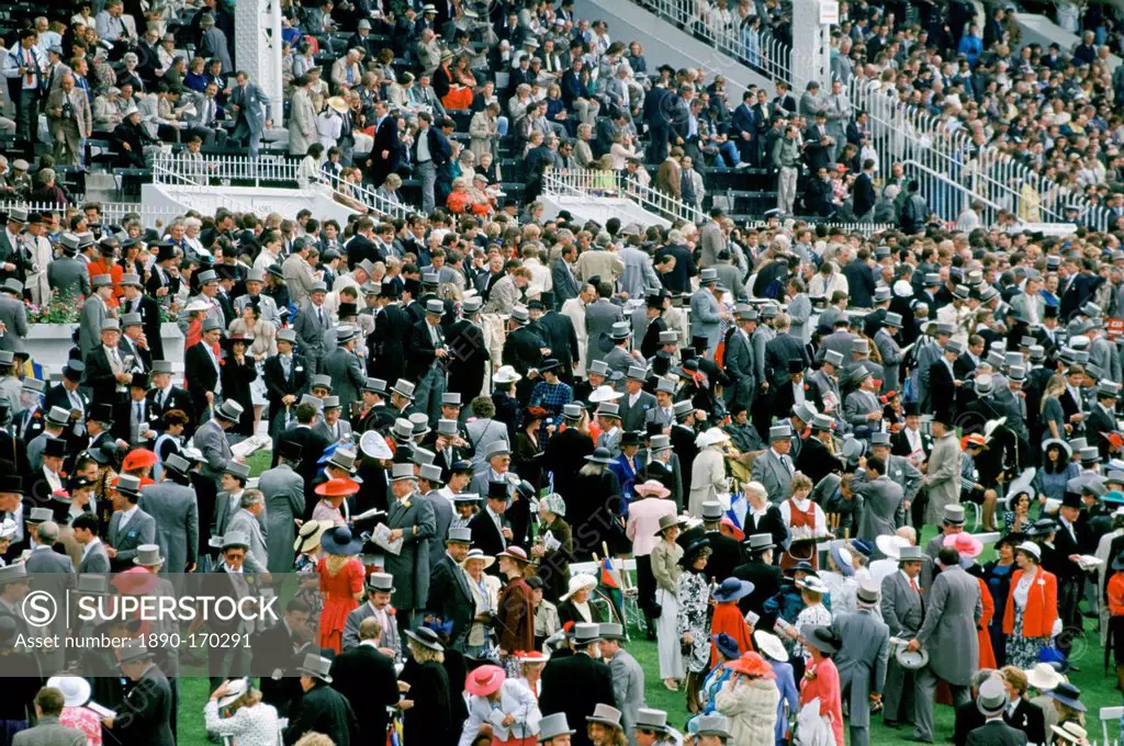 Crowds of spectactors in traditional top hats and tails at Epsom Racecourse for Derby Day, UK