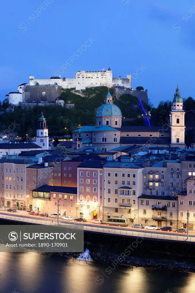 High angle view of the old town, UNESCO World Heritage Site, with Hohensalzburg Fortress, Dom Cathedral and Kappuzinerkirche Church at dusk, Salzburg,...