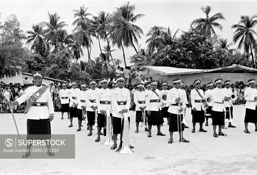 Soldiers in traditional uniforms wearing skirts in military parade in Kiribati, South Pacific