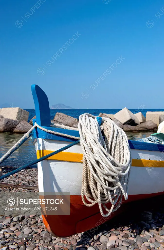 A colourful wooden fishing boat on the rocky beach at Lingua, Salina, The Aeolian Islands, off Sicily, Messina Province, Italy, Mediterranean, Europe