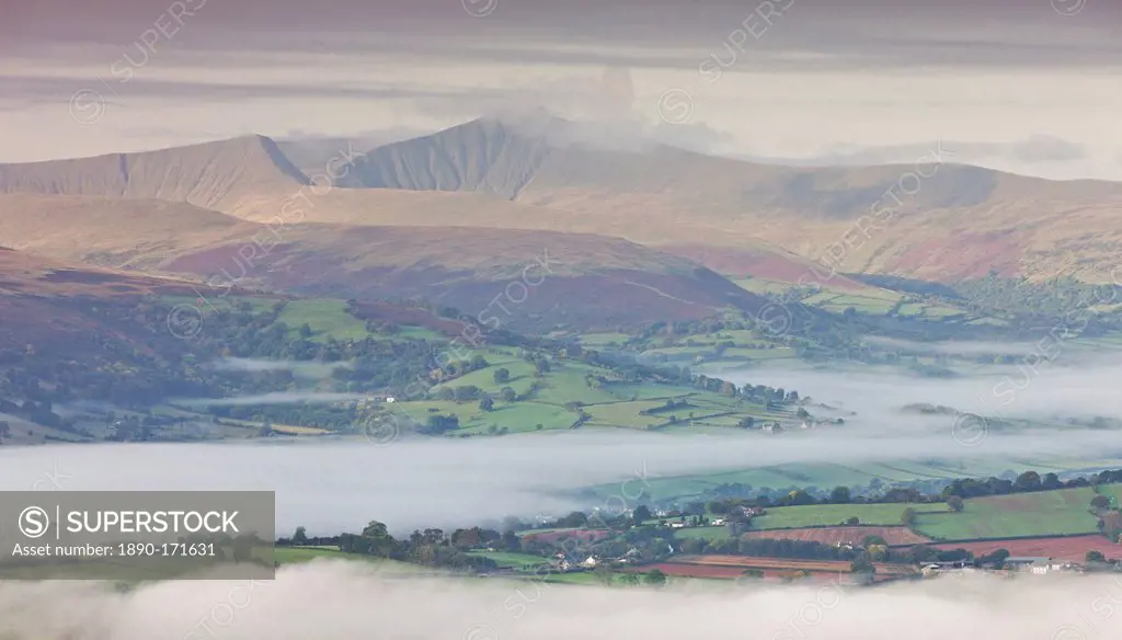 Mist covered rolling countryside in autumn backed by Pen y Fan mountain, Brecon Beacons, Powys, Wales, United Kingdom, Europe