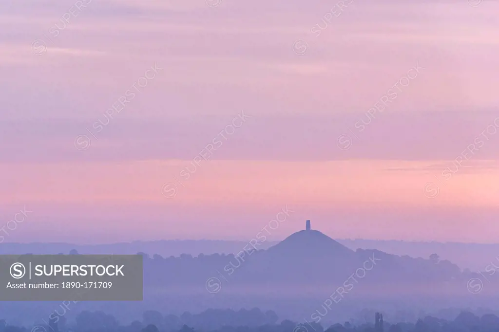 Glastonbury Tor rising surrounded by mist at dawn in summer, Somerset, England, United Kingdom, Europe