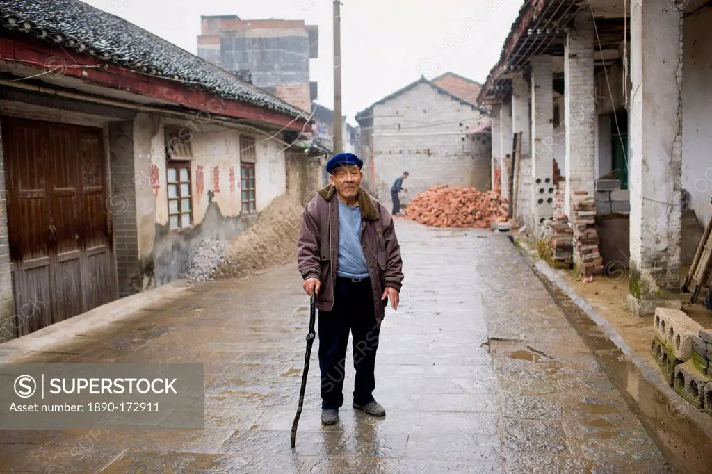 Elderly man with a walking stick in Fuli Old Town, Xingping, China