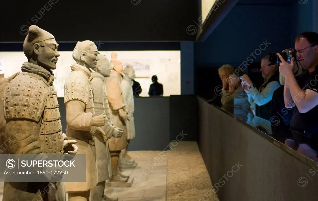 Tourists photograph Terracotta warriors on display in the Shaanxi History Museum, Xian, China