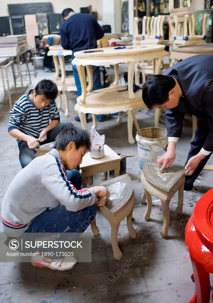 Marquetry craftsmen at work on lacquer tables at souvenir and furniture factory, Xian, China